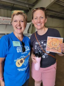 Tawni VanVleet and Victoria Vox holding Tawni's new 2023 CD titled "Tawni Rae"